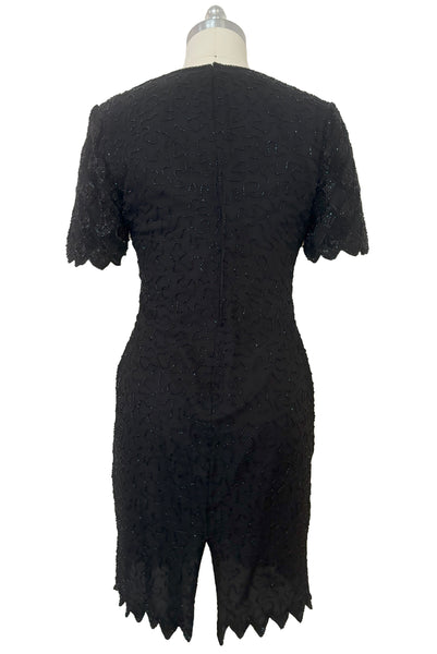 Back view of 1980s vintage diamonds black beaded and sequin silk chiffon crew neck, short sleeve, fitted knee length cocktail dress by Laurence Kazar, size medium to large.