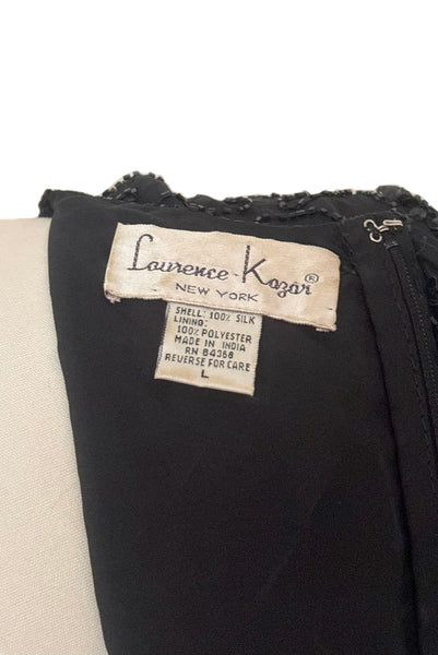 Interior detail view of 1980s vintage diamonds black beaded and sequin silk chiffon crew neck, short sleeve, fitted knee length cocktail dress by Laurence Kazar, size medium to large. Showing a close-up of the Laurence Kazar label, and size L & fabric content tag.
