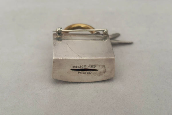 Horizontal bottom view of 1960s vintage Mexican 925 sterling silver and brass hollow padlock and key two tone statement brooch. Showing the "Mexico" and "925" stamps.