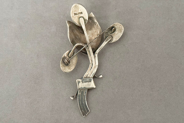 Horizontal back view of 1930s vintage Mexican 925 sterling silver flower statement brooch with oval cream cabochon stone.