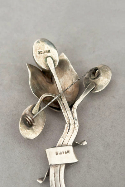 Detail view of 1930s vintage Mexican 925 sterling silver flower statement brooch with oval cream cabochon stone. Showing the "Mexico" and "Silver" stamps.
