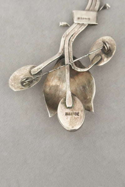 Detail view of 1930s vintage Mexican 925 sterling silver flower statement brooch with oval cream cabochon stone. Showing the "Mexico" and "Silver" stamps.