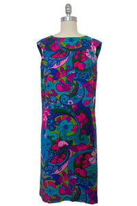 Front view of vintage 1960s blue, pink, purple, and green psychedelic floral print cotton shift dress, extra small to small.