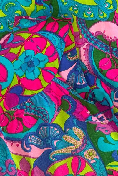 Interior detail view of vintage 1960s blue, pink, purple, and green psychedelic floral print cotton shift dress, extra small to small. Showing the finishing to the interior collar and the facings.