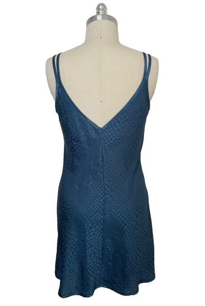 Back view of 1990s vintage dusty blue polyester jacquard satin bias cut short slip nightgown by Jones New York, size medium to large. Showing the V-cut back.