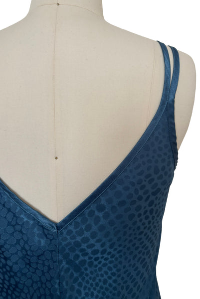 Detail view of 1990s vintage dusty blue polyester jacquard satin bias cut short slip nightgown by Jones New York, size medium to large. Showing the V back neckline and satin double straps.
