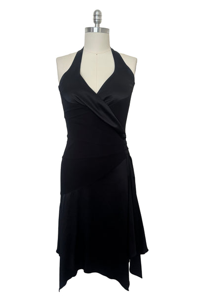 Front view of 1990s vintage black silk Lycra charmeuse and rayon jersey drop waist halter dress with handkerchief hem by Bebe, size small to medium.