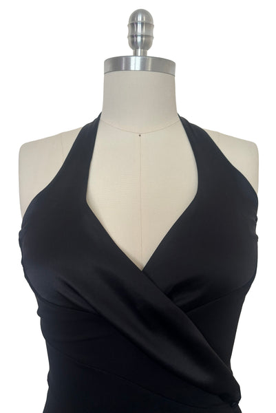 Detail view of 1990s vintage black silk Lycra charmeuse and rayon jersey drop waist halter dress with handkerchief hem by Bebe, size small to medium. Showing the halter neckline.