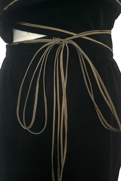 Front detail view of 1970s vintage rare designer Holly's Harp black velvet, gold metal cord trimmed wrap top & skirt set, extra small to small. Showing the dark gold metal cord.