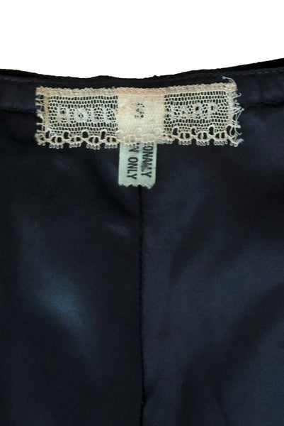Interior top detail view of 1970s vintage rare designer Holly's Harp black velvet, gold metal cord trimmed wrap top & skirt set, extra small to small. Showing the Holly's Harp label and size S tag.