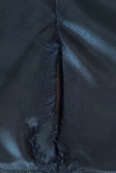 Interior top detail view of 1970s vintage rare designer Holly's Harp black velvet, gold metal cord trimmed wrap top & skirt set, extra small to small. Showing the friction fraying to the satin lining.