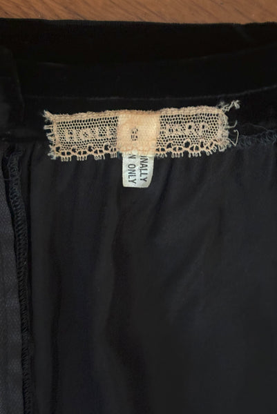 Interior top detail view of 1970s vintage rare designer Hollys Harp black velvet, gold metal cord trimmed wrap top & skirt set, extra small to small. Showing the Holly's Harp label and size 8 tag.