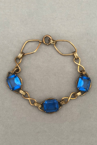 Vertical front view of 1930s vintage Art Deco blue rhinestone and 12kt gold fill link bracelet.
