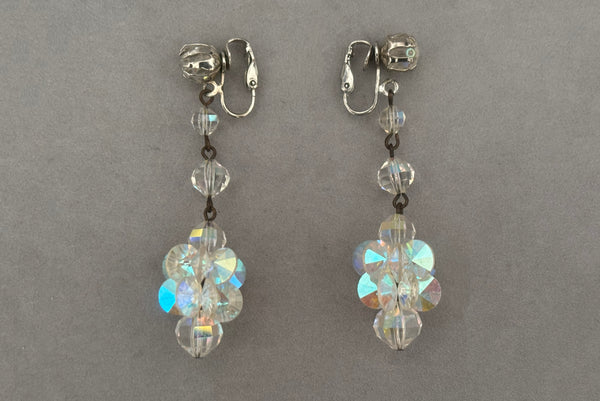 Horizontal side view of 1960s vintage iridescent crystal beaded drop clip-on earrings.