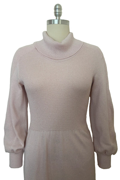Bodice front view of 1970s vintage blush pink turtleneck bishop sleeve acrylic polyester nylon blend sweater dress by JT Martin, size medium to large.