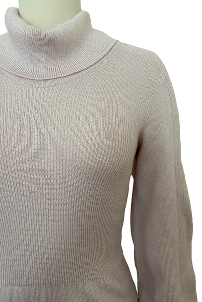 Detail view of 1970s vintage blush pink turtleneck bishop sleeve acrylic polyester nylon blend sweater dress by JT Martin, size medium to large. Showing the ribbed turned down neckline.