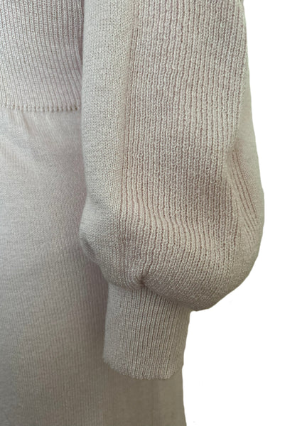 Detail view of 1970s vintage blush pink turtleneck bishop sleeve acrylic polyester nylon blend sweater dress by JT Martin, size medium to large. Showing the ribbed detailing on the sleeves and cuffs.