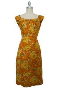 Front view of 1950s vintage mustard yellow, orange, green, and white autumnal floral sleeveless, gathered bust, wiggle dress by Alix of Miami, size extra small to small.