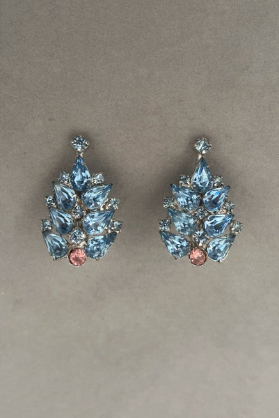 Vertical front view of 1950s vintage silver tone blue and pink rhinestone screw back earrings.