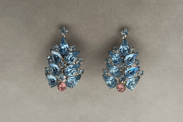 Horizontal front view of 1950s vintage silver tone blue and pink rhinestone screw back earrings.