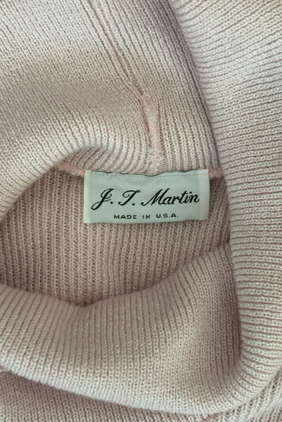 Interior detail view of 1970s vintage blush pink turtleneck bishop sleeve acrylic polyester nylon blend sweater dress by JT Martin, size medium to large. Showing the J.T. Martin label.