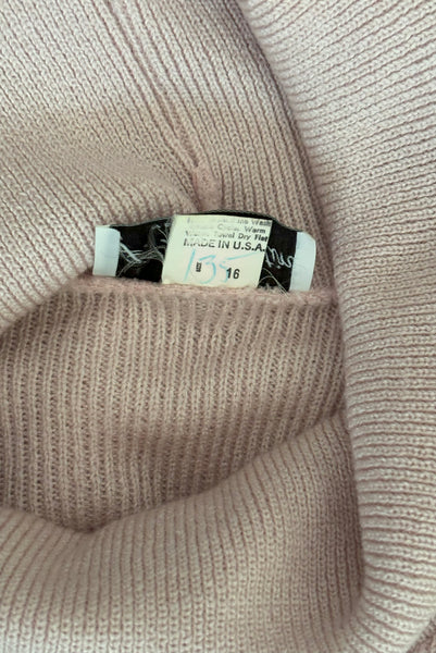 Interior detail view of 1970s vintage blush pink turtleneck bishop sleeve acrylic polyester nylon blend sweater dress by JT Martin, size medium to large. Showing the made in the USA tag.