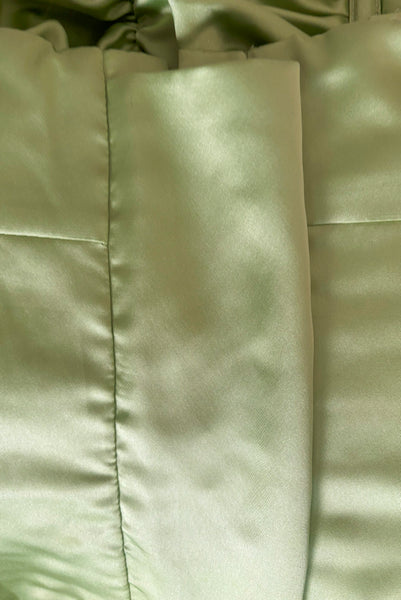 Interior detail view of 1990s vintage peridot green quilted satin corset/bustier by John Festa, small to medium. New without tags. Showing the inner modesty panel.