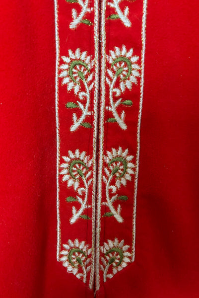 Detail view of 1960s vintage orange fleece, zip front housecoat with white, green, and gold floral embroidery by Evelyn Parsons, size medium to large. Showing the zipper placket with floral embroidery.