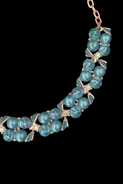 Detail view of 1950s vintage teal blue textured plastic bead and iridescent rhinestone silver tone necklace. Showing a close up of the bead and rhinestone links.
