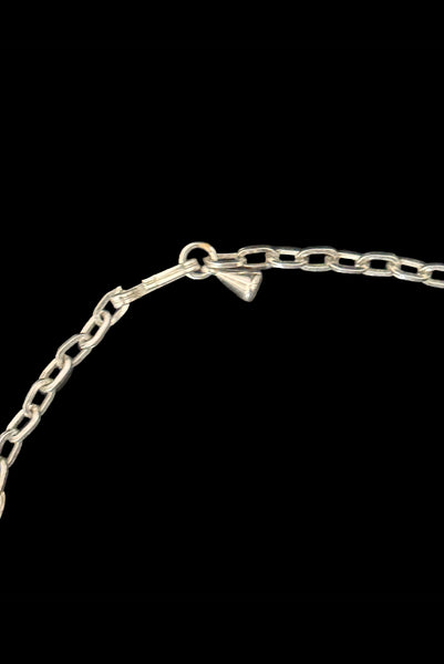 Detail view of 1950s vintage teal blue textured plastic bead and iridescent rhinestone silver tone necklace. Showing the adjustable hook closure.
