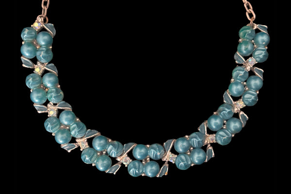 Detail view of 1950s vintage teal blue textured plastic bead and iridescent rhinestone silver tone necklace. Showing a close up of the bead and rhinestone links.