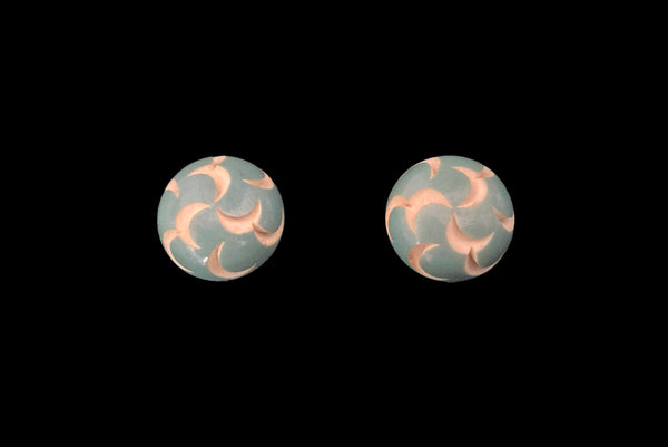 Horizontal front view of 1930s vintage cut through aqua blue resin washed cream carved Bakelite screw-back button earrings.