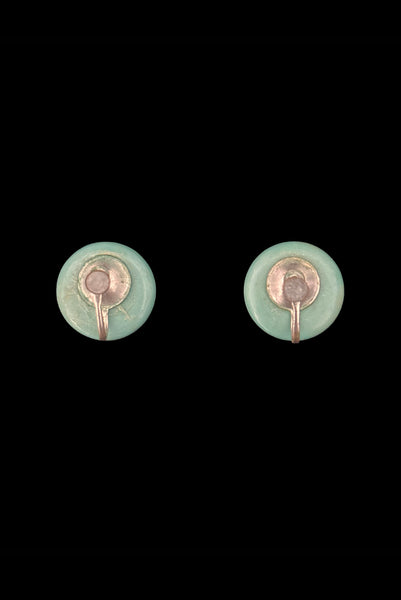 Vertical back view of 1930s vintage cut through aqua blue resin washed cream carved Bakelite screw-back button earrings.