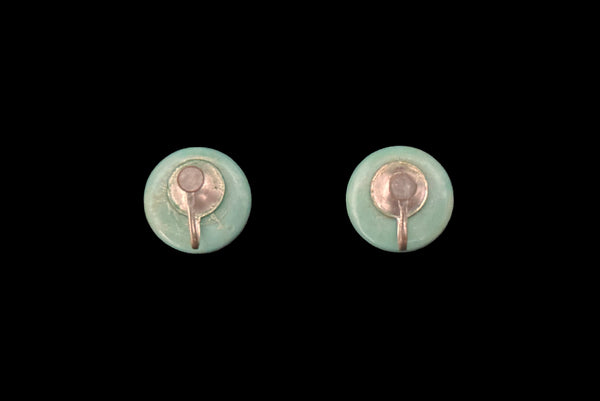 Horizontal back view of 1930s vintage cut through aqua blue resin washed cream carved Bakelite screw-back button earrings.