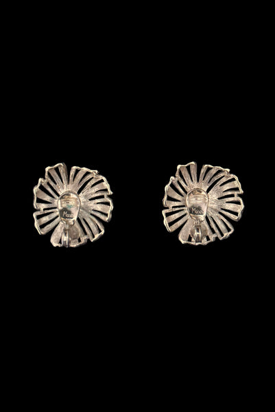 Vertical back view of 1960s vintage large round gold tone floral clip-on earrings by Monet.