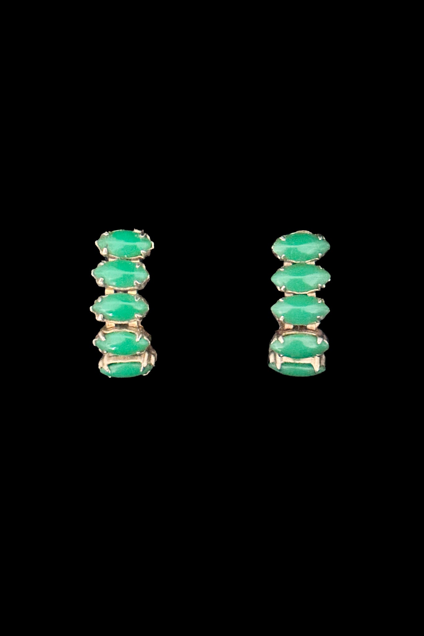 Vertical front view of 1950s vintage green marquise cabochon gold tone clip -on hoop earrings.