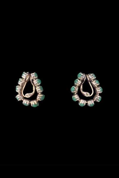Vertical side view of 1950s vintage green marquise cabochon gold tone clip -on hoop earrings.