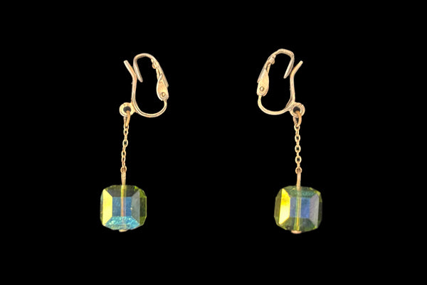 Horizontal side view of 1960s vintage square green iridescent crystal bead and gold tone chain link drop faux pierced clip-on earrings.