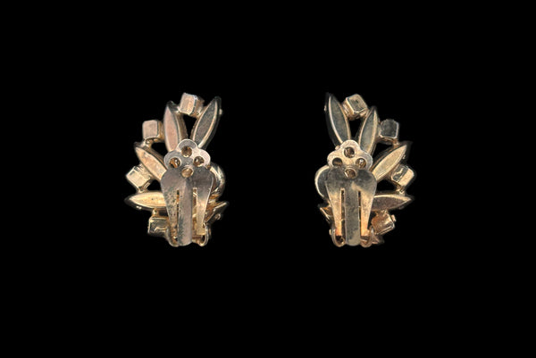 Horizontal back view of 1950s vintage green marquise and blue iridescent round rhinestone fan shaped clip-on earrings.