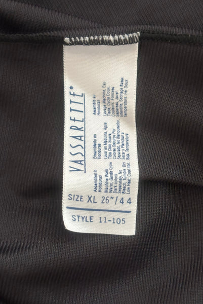 Interior detail view of 1990s vintage black nylon and lace lingerie half slip by Vassarette, size large to extra large. Showing a close-up of the Vassarette label.