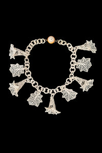 Vertical front view of 1930s vintage cream lace look floral and leaf celluloid plastic statement necklace.
