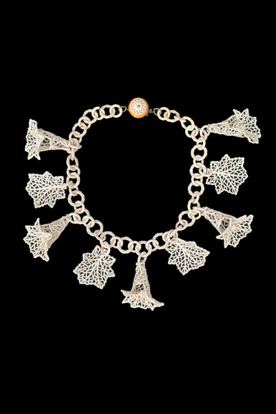 Vertical front view of 1930s vintage cream lace look floral and leaf celluloid plastic statement necklace.