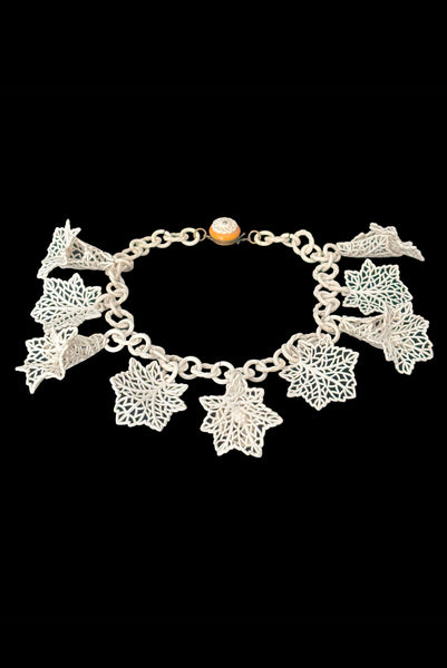 Vertical perspective view of 1930s vintage cream lace look floral and leaf celluloid plastic statement necklace.
