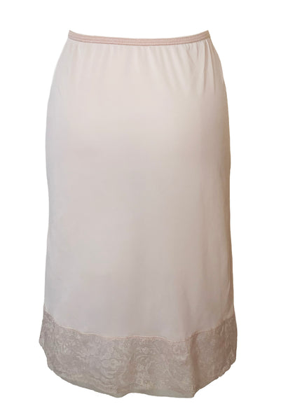 Back view of 1950s vintage pale pastel pink nylon half slip with mesh and lace hem by Komar Lingerie, size small to medium.