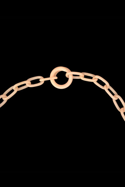 Detail view of 1930s vintage blush pink three-dimensional floral celluloid plastic statement necklace. Showing the celluloid loop clasp.