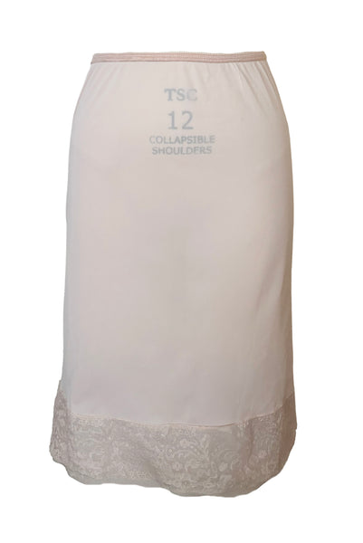 Front view of 1950s vintage pale pastel pink nylon half slip with mesh and lace hem by Komar Lingerie, size small to medium.