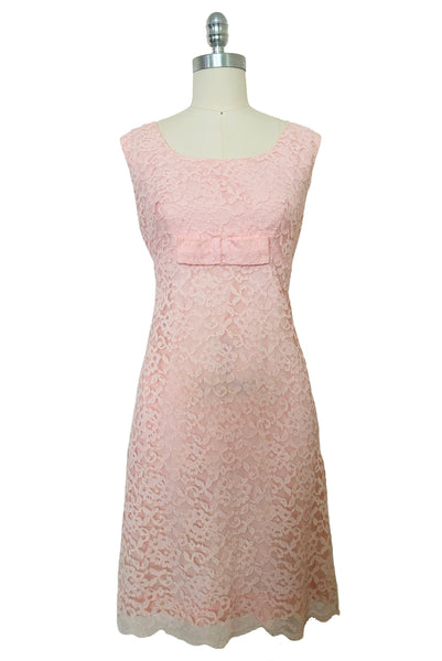 Front view of 1960s vintage pink lace Mod empire waist cocktail shift dress, size medium to large.