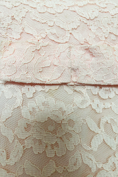 Detail view of 1960s vintage pink lace Mod empire waist cocktail shift dress, size medium to large. Showing a close-up of the pale pink corded lace.