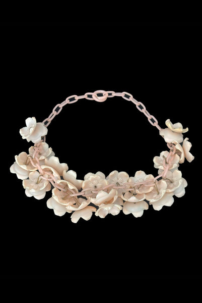 Vertical back view of 1930s vintage blush pink three-dimensional floral celluloid plastic statement necklace.