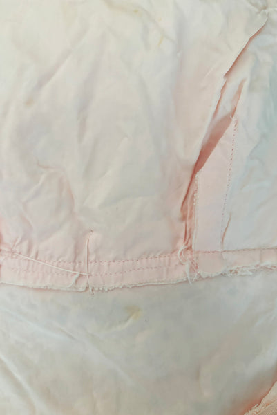 Interior detail view of 1960s vintage pink lace Mod empire waist cocktail shift dress, size medium to large. Showing a small spot on the lining.